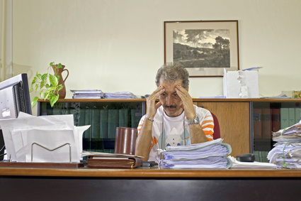 Discouraged manager man at his desk in the office Fotolia 25253215 XS Chiropractic Freedom Package New for 2012